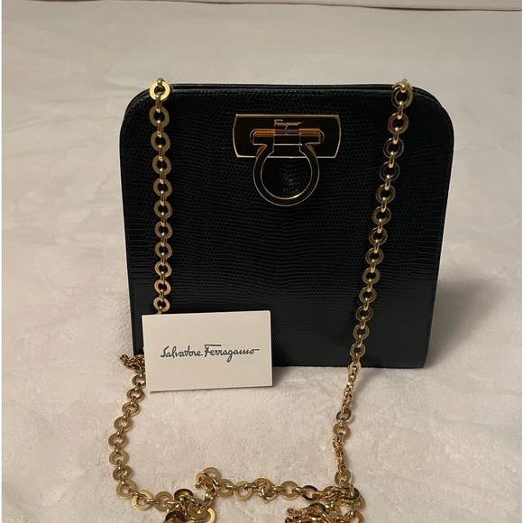 Authentic Salvatore Ferragamo black leather bag with shiny gold metal handle. - Picture 1 of 11